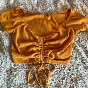 Orange/Yellow ribbed crop top with string to adjust length.